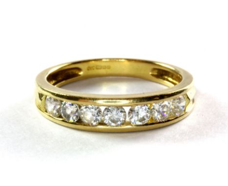 An 18ct yellow gold stone set half eternity ring, (O.5). Approx. 3.5g