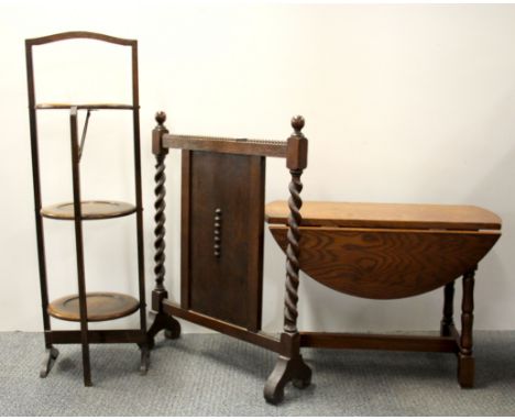 An oak three tier cake stand, fire screen and drop leaf table.