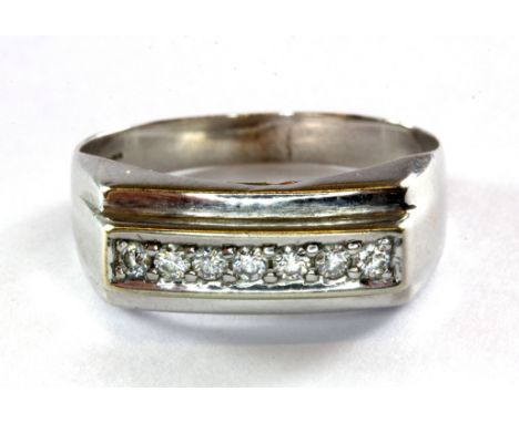 A gent's 9ct (stamped 375) white gold seven diamond set ring, (T.5), approx. 2.8g.