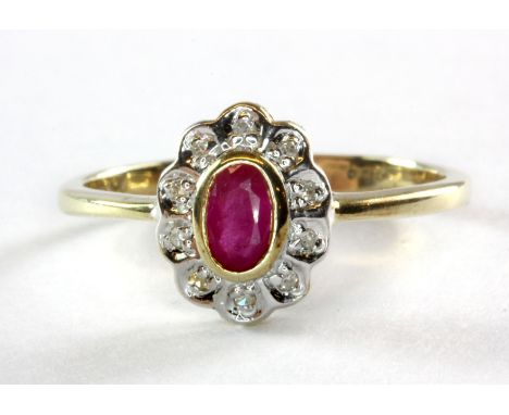 A 9ct yellow gold ruby and diamond set cluster ring, (L.5).