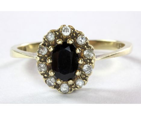 A 9ct (worn mark) yellow gold sapphire and diamond set cluster ring, (N.5).