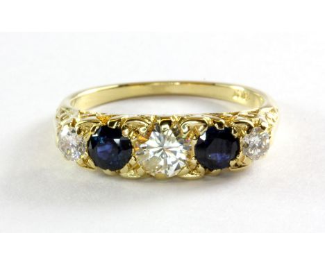 An 18ct (stamped 18ct) yellow gold sapphire and diamond five stone set ring, centre stone approx. 0.5ct, (N.5).