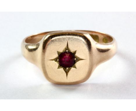 A 9ct rose gold red stone set signet ring, (Q.5).