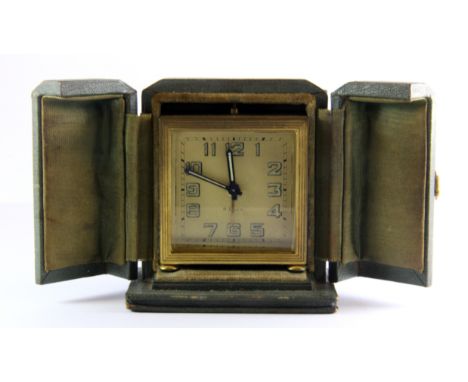 A cased 1930's gilt travel alarm clock, H. 9cm.