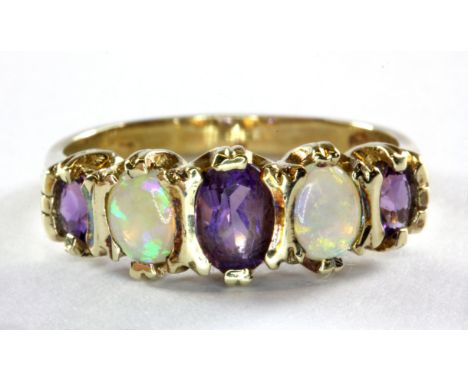 A 9ct yellow gold amethyst and opal set half eternity ring, (O).