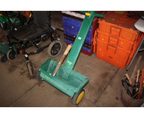 A lawn spreader; together with a hammer etc