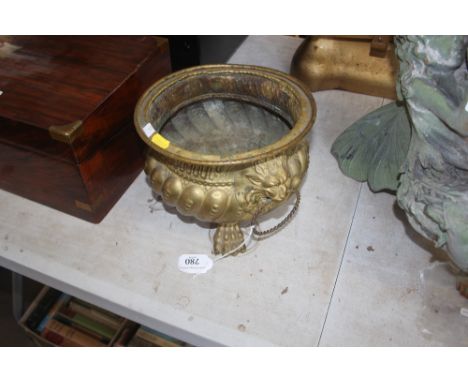 A 19th Century gilded brass planter; with lion mask decoration