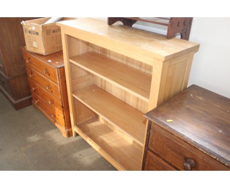 A light oak open fronted bookcase