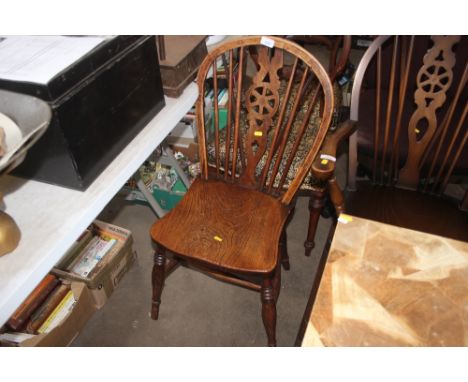 An elm seated stick and wheel back kitchen chair