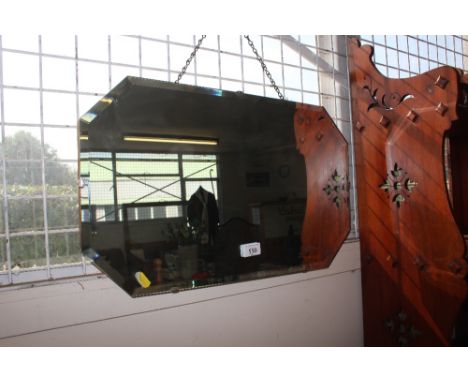 An unframed bevel edge wall mirror