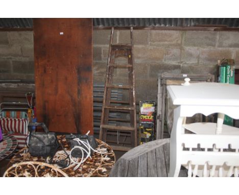 A pair of vintage folding steps with hand holds at top