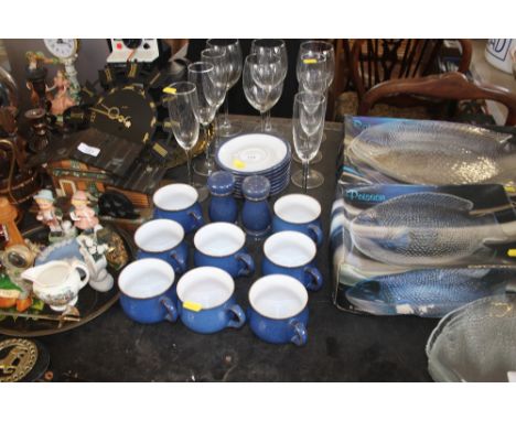 A quantity of Denby blue glazed teacups and saucers and a quantity of wine glasses