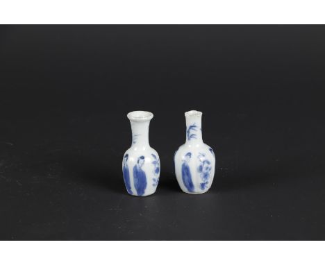 Two porcelain small model belly vases with long body decoration. China, Kangxi. Damage to neck. H.: 5 cm. 