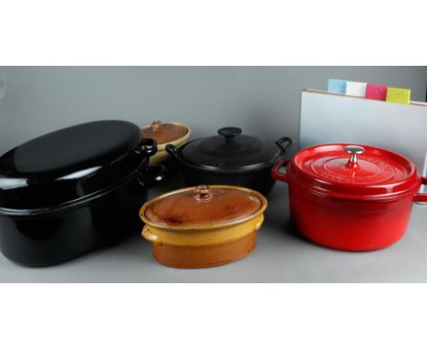 An Acotte Staub cast iron red enamel casserole. In addition, a Joseph Joseph cutting board set. In addition, some other pans 