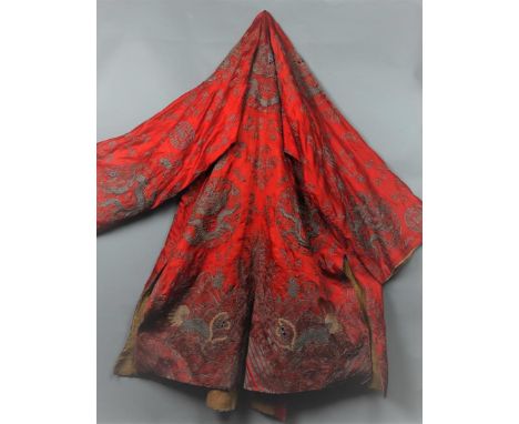A 19th century embroidered silk cloak, decorated with dragons and Chinese characters.