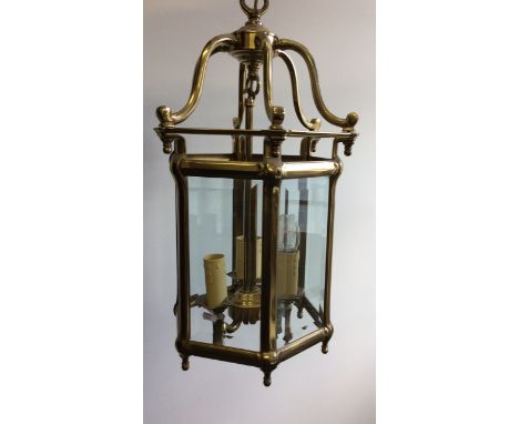 A heavy brass six glass panelled ceiling lantern light fitting