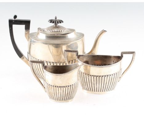 A matched Walker &amp; Hall silver tea set, comprising a teapot hallmarked Sheffield 1918, a milk jug hallmarked Sheffield 19