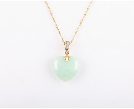 A jade heart pendant on a gold chain stamped 9K.
