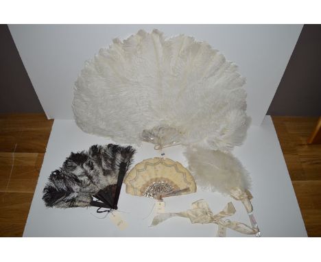Early 20th Century fans, to include: a white ostrich and mother-of-pearl fan; another ostrich with tortoiseshell sticks, silk
