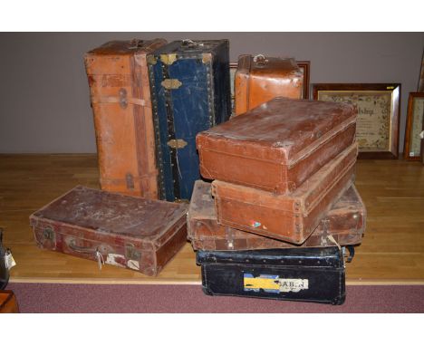 A blue metal bound travelling trunk; together with seven antique suitcases.  (8)
