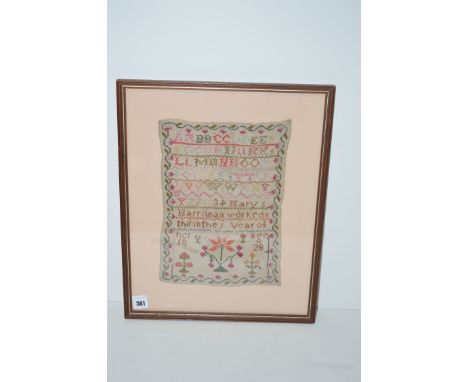 An early 19th Century needlework sampler, alphabet and numbers, stylized floral decoration, worked by Mary Harriman, aged 13,