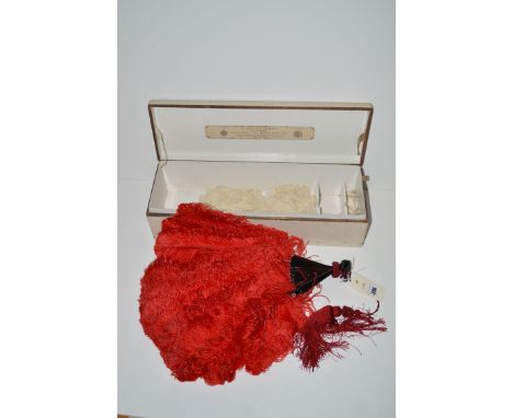 A red ostrich feather and tortoiseshell stick fan, by J. Duvelleroy, London, with red silk tassel, in original fitted box.