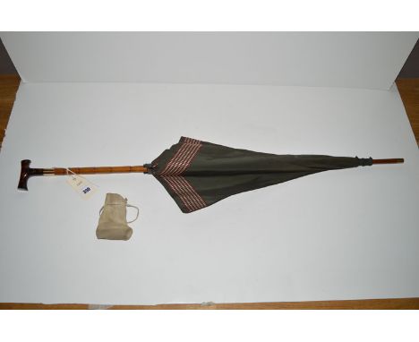 An early 20th Century Brigg parasol, green silk canopy with red and white border, bamboo handle, gold mount, above tortoisesh