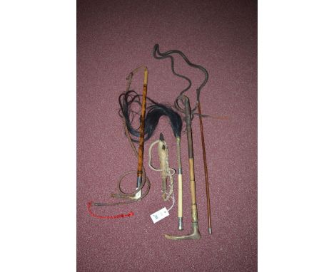 Riding crops, to include: a cane, leather and antler with silver mount; a similar example with metal mount; a leather and dee