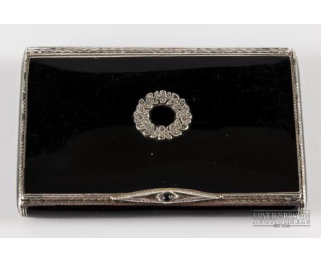 A Continental 925 marked silver enamelled compact, the black enamel inset with marcasite garland, engine turned edges, import