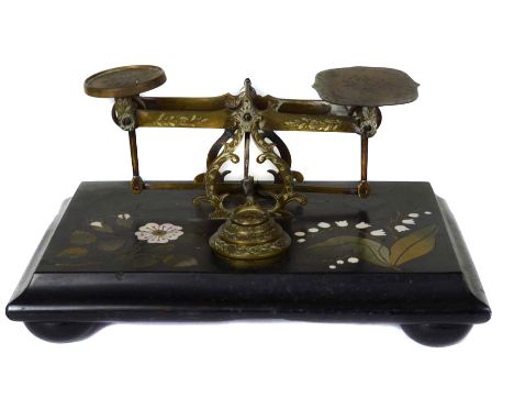 An Ashford black marble base postage scale, inlaid with wild rose and lily of the valley sprays in pietra dura style, the bra