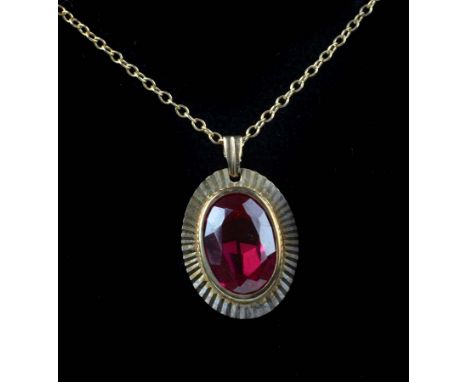 A 9ct gold and synthetic ruby single stone pendant, on a fine 9ct gold trace link chain (2)