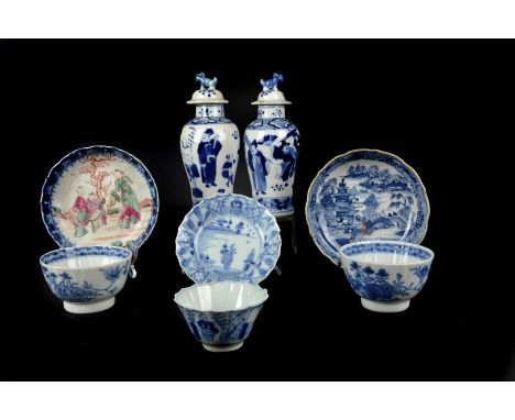 Two Chinese blue and white porcelain vases and covers, painted with figures beneath domed covers with dogs of fo finials; a b