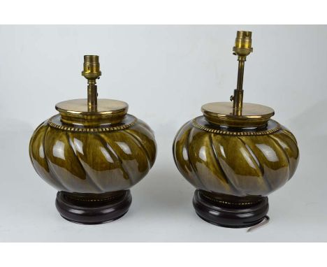 A pair of Continental pottery lamp bases, dark green glazed, of ribbed globular form, fitted for electricity, 18cm high inclu