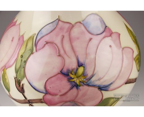A large Moorcroft Pottery lamp base in Magnolia pattern, tubelined with pink flower stems on a pale cream ground, impressed m