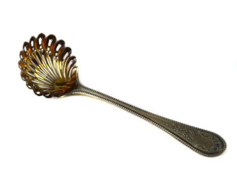 A Victorian silver sugar sifter ladle, of pierced gilded shell form bowl with beaded handle, Sheffield 1869, makers mark of R