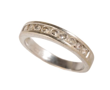 A DIAMOND HALF ETERNITY RING nine brilliant-cut diamonds, rub over set on a 9ct white gold shank, ring size M-N