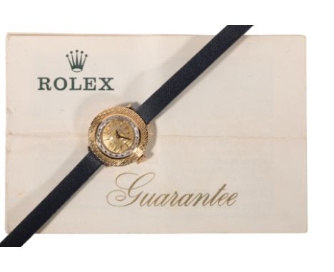 ROLEX: AN 18CT GOLD LADY'S WRISTWATCH with manual wind movement, gold dial, gold baton numerals and gold hands, on a black le