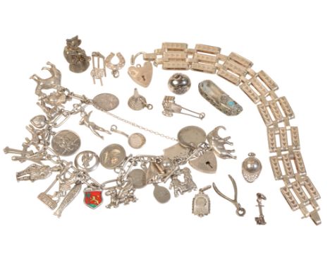 A SILVER CHARM BRACELET with twenty-six silver and unmarked white metal charms attached, together with a collection of ten ot