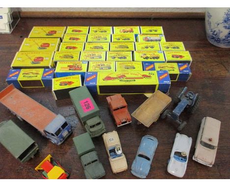 A collection of vintage toy vehicles to include boxed Matchbox diggers, trucks and tipper trucks