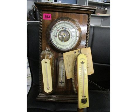 An early 20th century oak hall set with a barometer and brushes