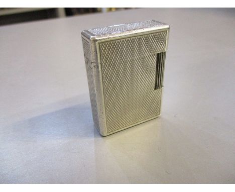A white metal cased DuPont lighter with engine turned decoration