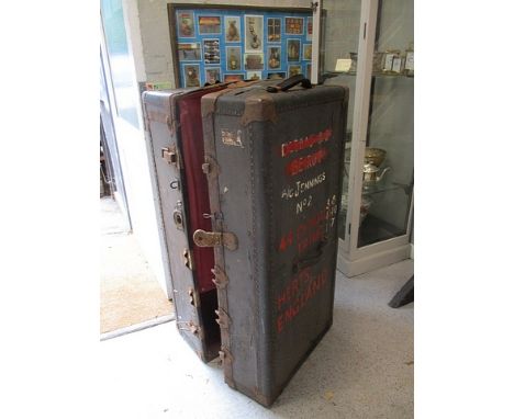 A Great War era black clad trunk enclosing five drawers and a hanging rail, 44 h, 21 w, 18d