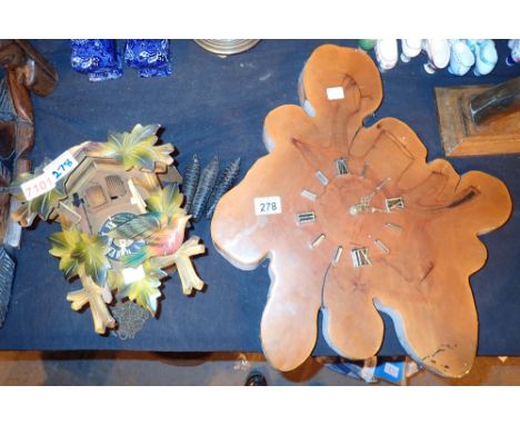 Triple weight cuckoo clock and a quartz tree trunk clock 