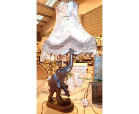 Wall hanging elephant on brass plaque with carved elephant table lamp  CONDITION REPORT: All electrical items in this lot hav