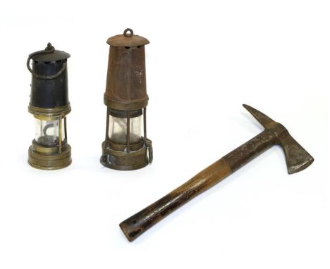 Miners' Lamps one stamped '937' the other unmarked; together with an ARP Fire Axe stamped '1940 The Defiant' (3)
