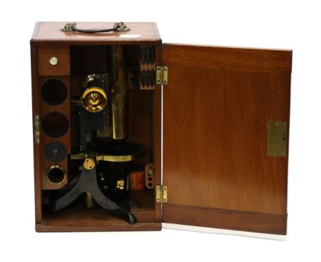 Swift & Son (London) Microscope with brass barrel, single lens, circular stage, black lacquered tilting stand, in mahogany ca