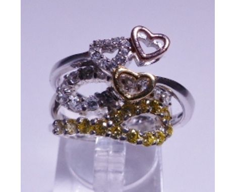 TWO STERLING SILVER RINGS. Sterling silver three heart ring, size V and sterling silver yellow and white stone ring, size L/M