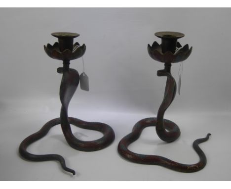 A Pair of Indian Brass and Enamel Candle Sticks, in the form of cobras, together with a copper trivet. (3)