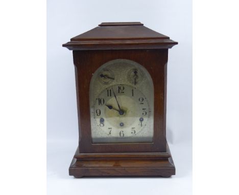 An Oak Mantle Chiming Clock, the clock having a German 18 cms movement, silvered face and Roman dial, approx 18 cms.