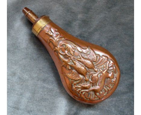 An Antique Copper Powder Flask, decorated with game scene, four position adjustable nozzle.